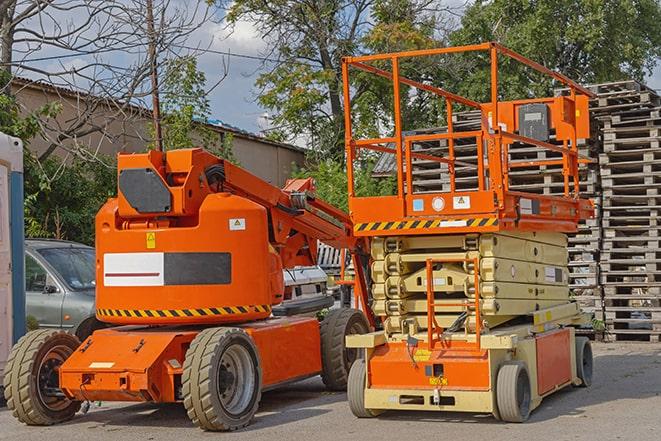 industrial forklift transporting goods in a warehouse setting in Oshtemo